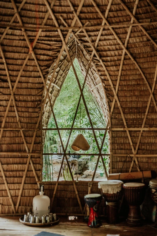 a living room filled with lots of wooden furniture, inspired by Saneatsu Mushanokōji, pexels contest winner, renaissance, tribe huts in the jungle, large round window, ribbon chapel, cone shaped