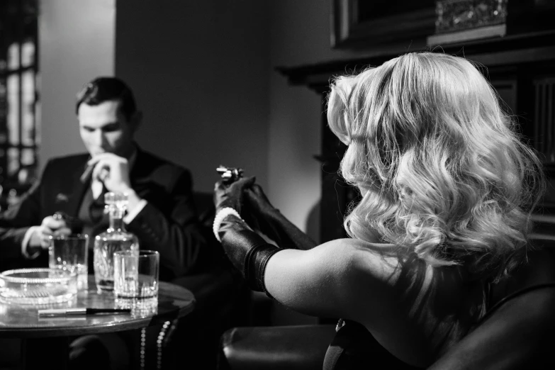 a man and a woman sitting at a table, by David Donaldson, pexels, pulp noir, drinking and smoking, david gandy, black canary