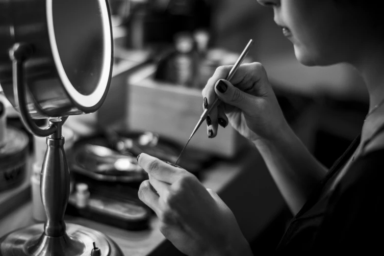 a woman brushes her teeth in front of a mirror, a black and white photo, by Adam Marczyński, pexels contest winner, jewelry lighting, inspect in inventory image, artisan, making of