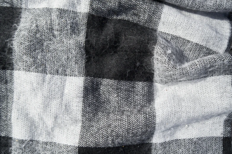 a close up of a black and white checkered shirt, inspired by Patrick Pietropoli, process art, 8k fabric texture details, destroyed clothes, scarf, transparent cloth