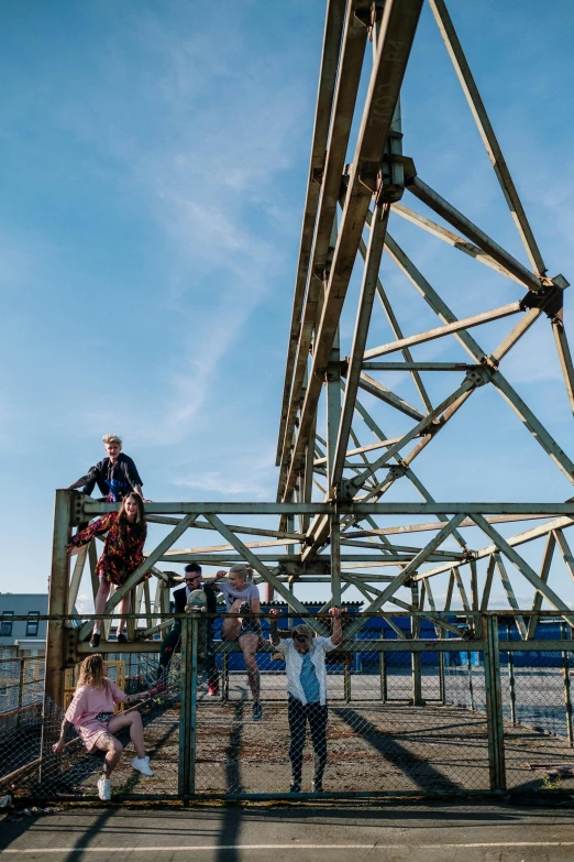 a group of people standing on top of a bridge, by The Family Circus, kinetic art, scrapyard, maryport, roller coasters, truss building