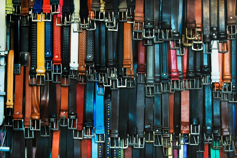 a wall filled with lots of different colored belts, by Nicolette Macnamara, pexels, square, wearing leather, conveyor belts, australian