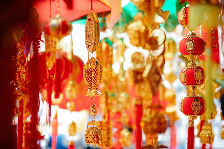 a bunch of red and gold decorations hanging from a ceiling, pexels contest winner, cloisonnism, street lanterns, 🦩🪐🐞👩🏻🦳, gold jewellery, a brightly coloured