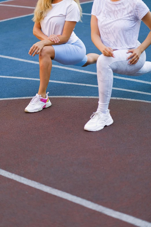 a couple of women sitting on top of a tennis court, trending on pexels, antipodeans, sprinters in a race, vastus lateralis, gradient, lower body