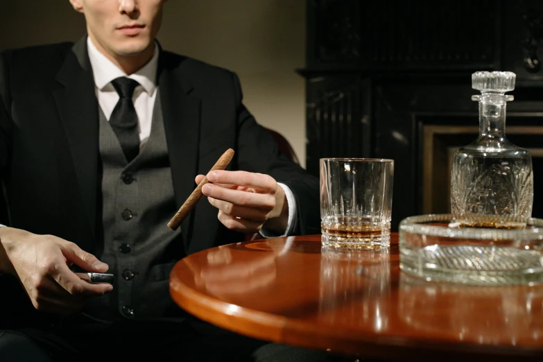 a man sitting at a table with a cigar in his hand, inspired by William Grant Stevenson, pexels, pinstripe suit, lounge, lachlan bailey, hunting