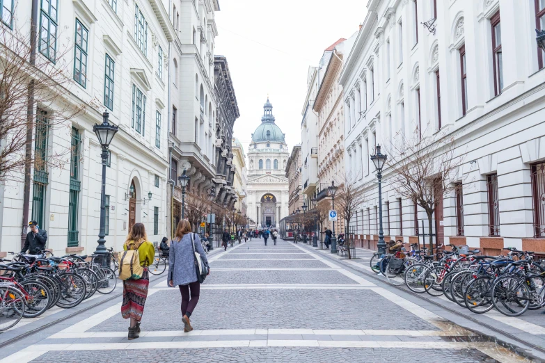 a couple of people that are walking down a street, pexels contest winner, viennese actionism, budapest street background, square, college, white marble buildings