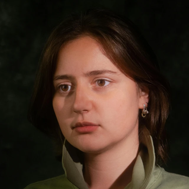 a close up of a person wearing a green shirt, a character portrait, inspired by Anna Füssli, polycount, photorealism, highly detailed vfx portrait of, ilya, pouty face, an ai generated image