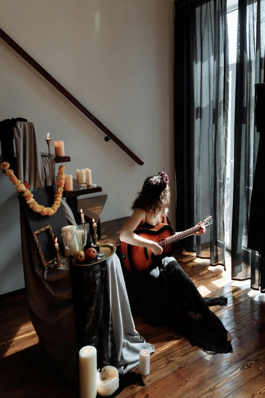 a woman sitting in a chair reading a book, an album cover, inspired by Josefina Tanganelli Plana, unsplash, renaissance, guitar solo, halloween atmosphere, near the window, on the altar