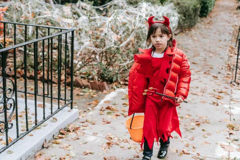 a little girl dressed up in a devil costume, by Nina Hamnett, pexels contest winner, humans of new york, the gruffalo, trick or treat, dwell