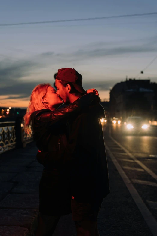 a man and a woman kissing on a bridge, trending on pexels, happening, dusk on a city street, hugging, bisexual lighting, confident looking