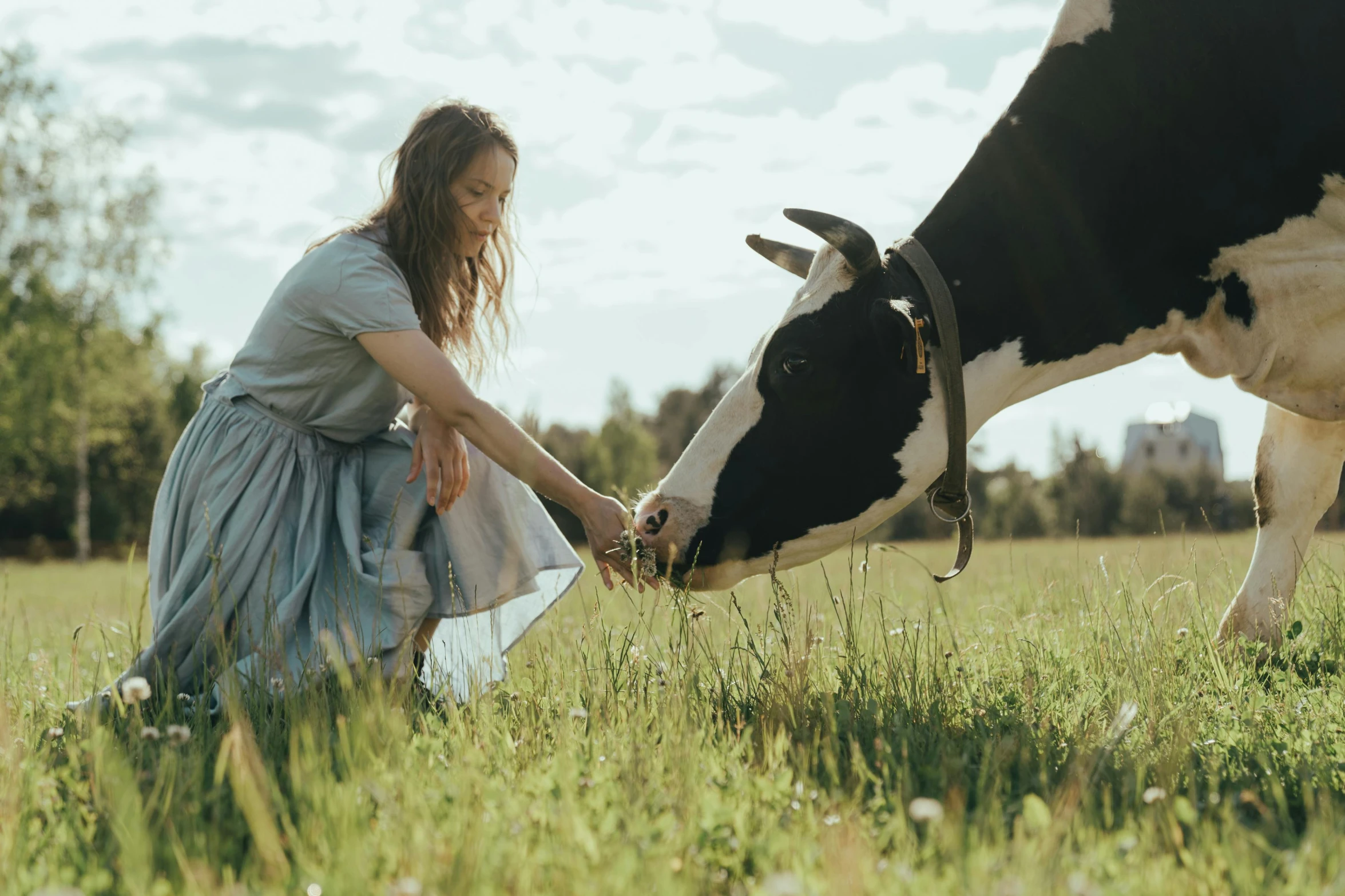 a woman is petting a cow in a field, by Emma Andijewska, organic dress, **cinematic, milk, description