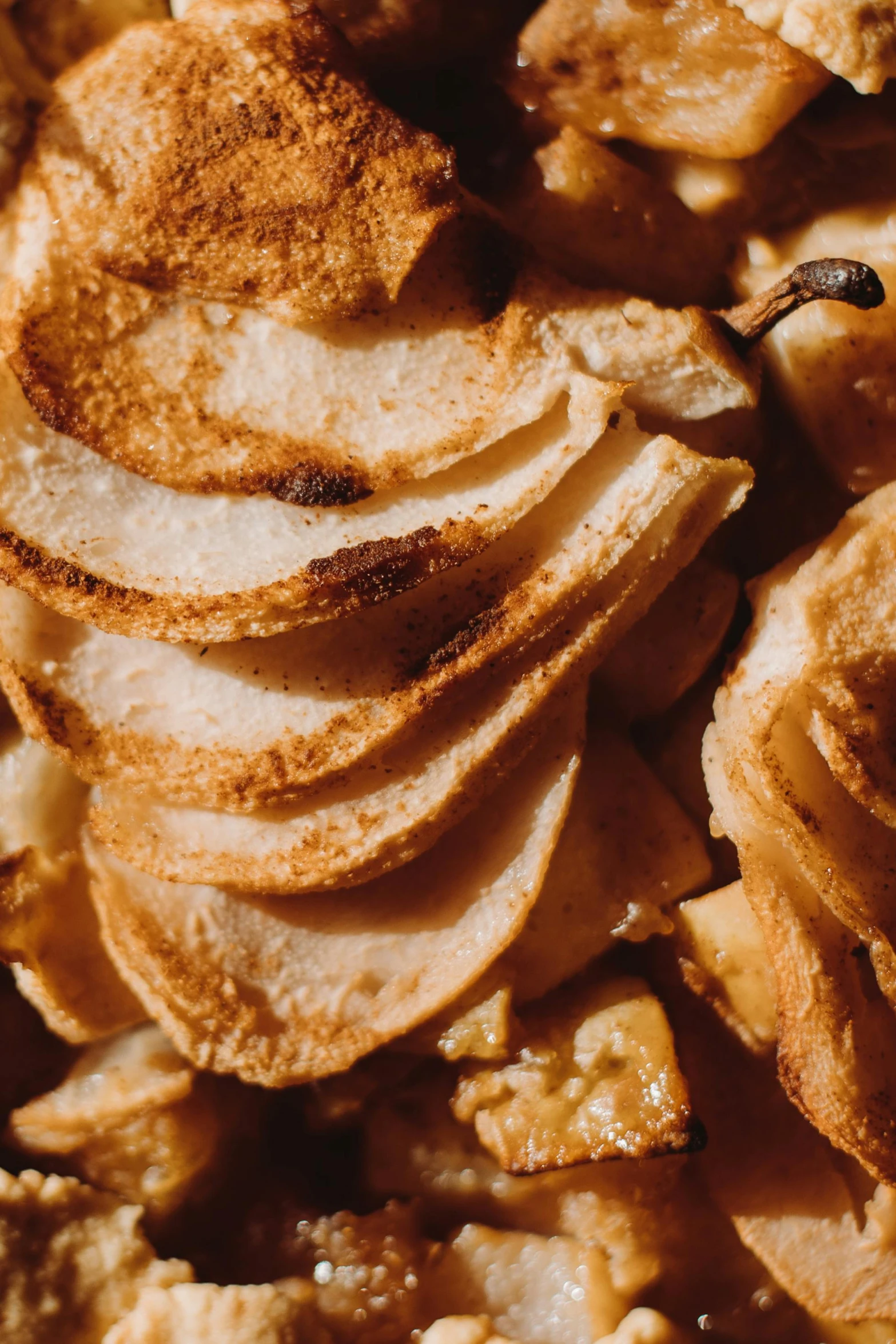 a close up of some food on a plate, pears, many golden layers, brown holes, perfect crisp light