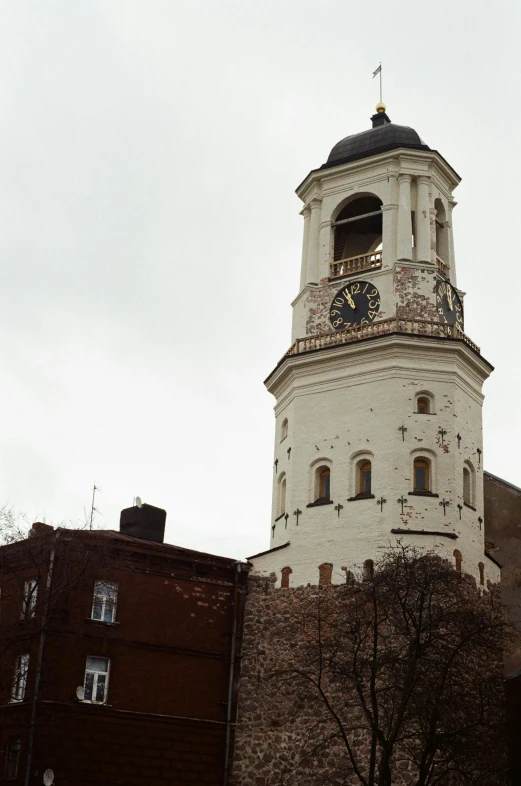 a tall tower with a clock on top of it, inspired by Vytautas Kasiulis, romanesque, demolition, panoramic shot, very poor quality of photography, neoclassical tower with dome
