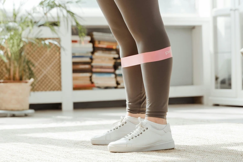 a close up of a person wearing a pair of leggings, a picture, trending on pexels, happening, wearing a pink head band, dingy gym, pastell colours, at home