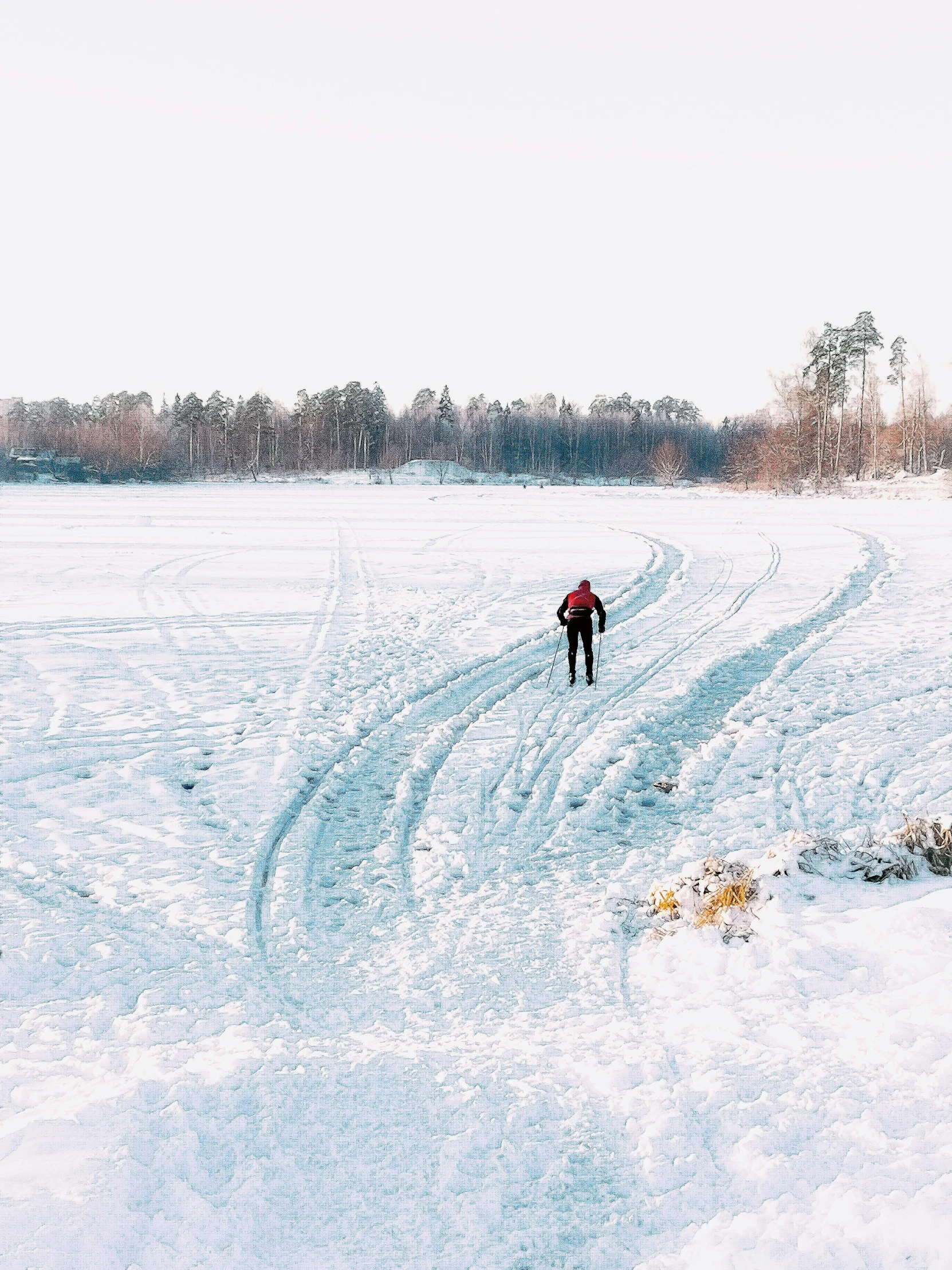 a person riding skis across a snow covered field, by Veikko Törmänen, pexels contest winner, hurufiyya, instagram story, near a lake, 8 k ), walking to the right