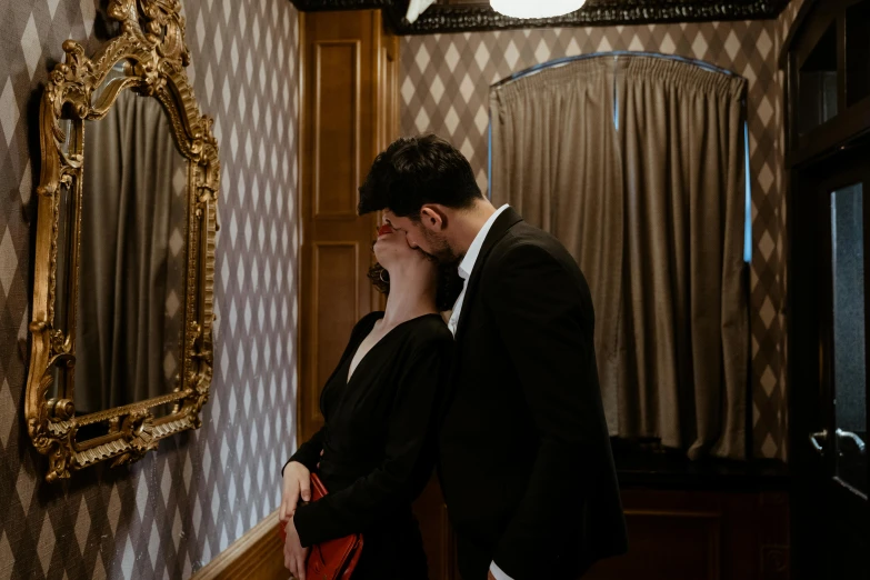 a man and a woman standing in front of a mirror, by Emma Andijewska, pexels contest winner, reylo kissing, gothic mansion room, in an elevator, sydney hanson