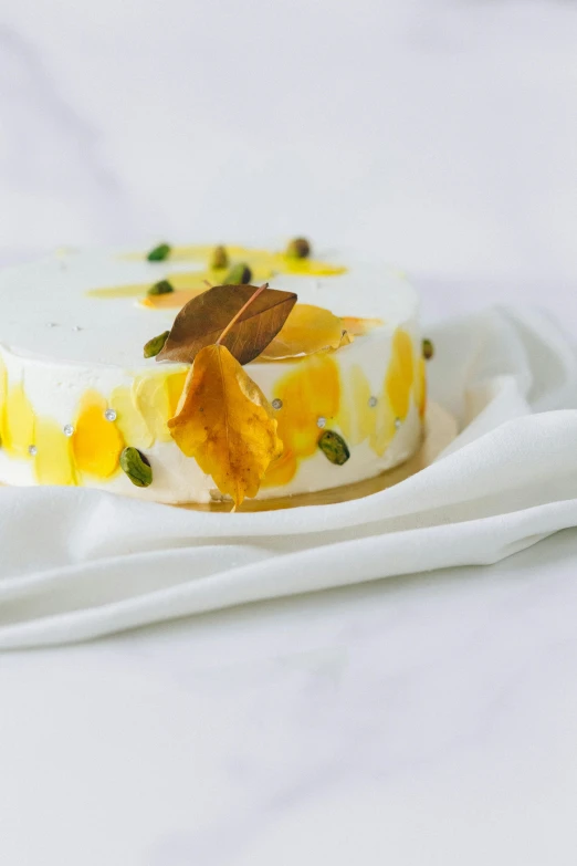 a dessert sitting on top of a white plate, a still life, inspired by Charles Le Roux, unsplash, arabesque, white and yellow scheme, made of silk paper, panoramic, resin