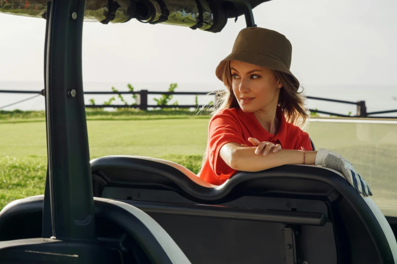 a woman sitting in the driver's seat of a golf cart, by Julia Pishtar, red hat, avatar image, outdoor photo, thumbnail