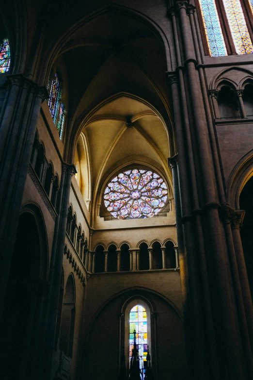 the inside of a cathedral with stained glass windows, a picture, unsplash contest winner, romanesque, somber colors, round windows, pink and gold color scheme, carcassonne