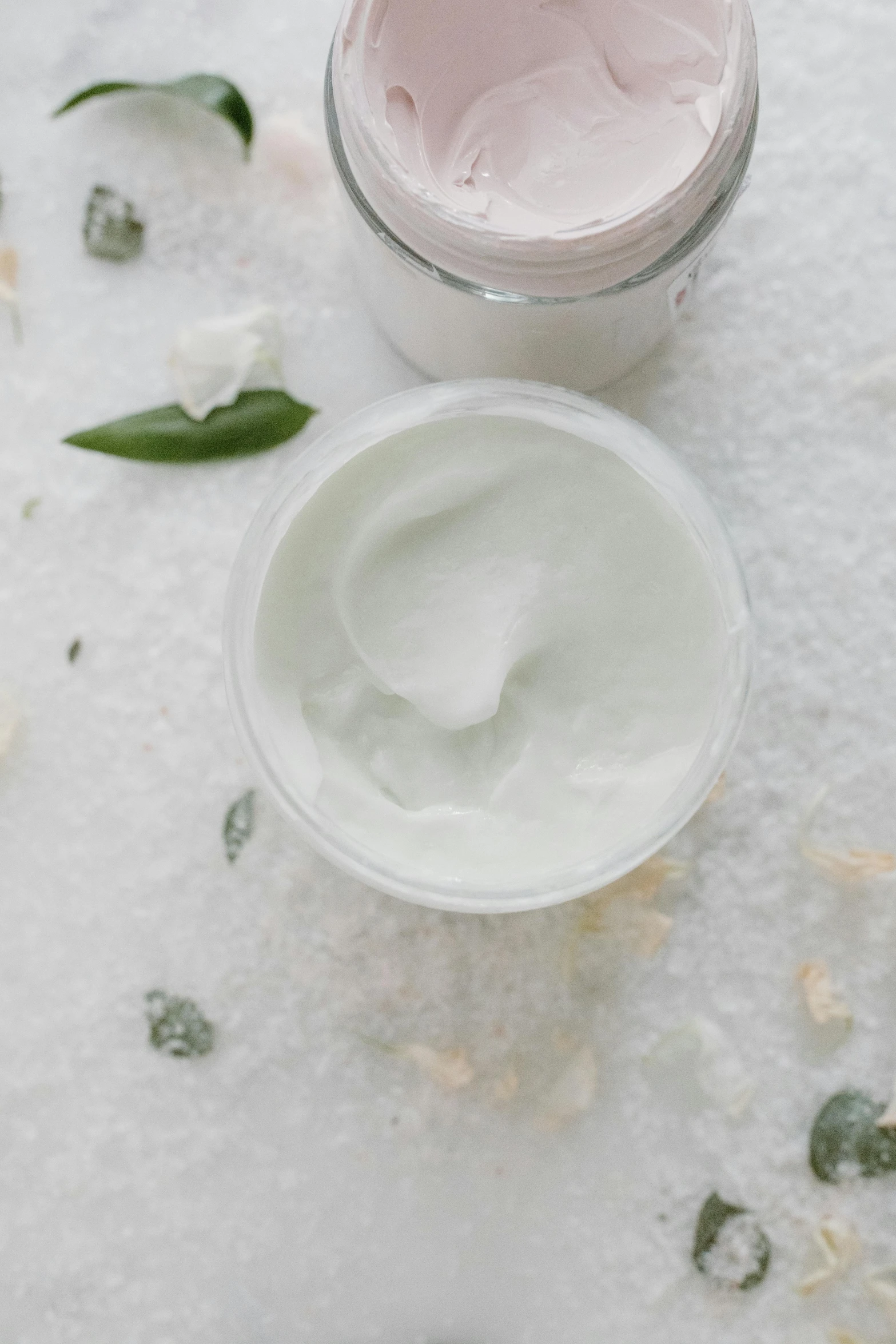a jar of cream next to a jar of cream, detailed product image, botanicals, zoomed in, silky texture