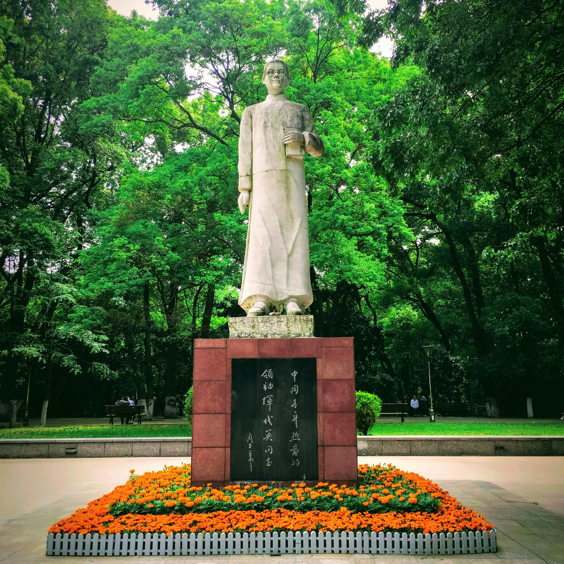 a statue of a man standing in the middle of a park, inspired by Zhang Shunzi, visual art, flowers around, 🚿🗝📝, obelisk, dressed a long white