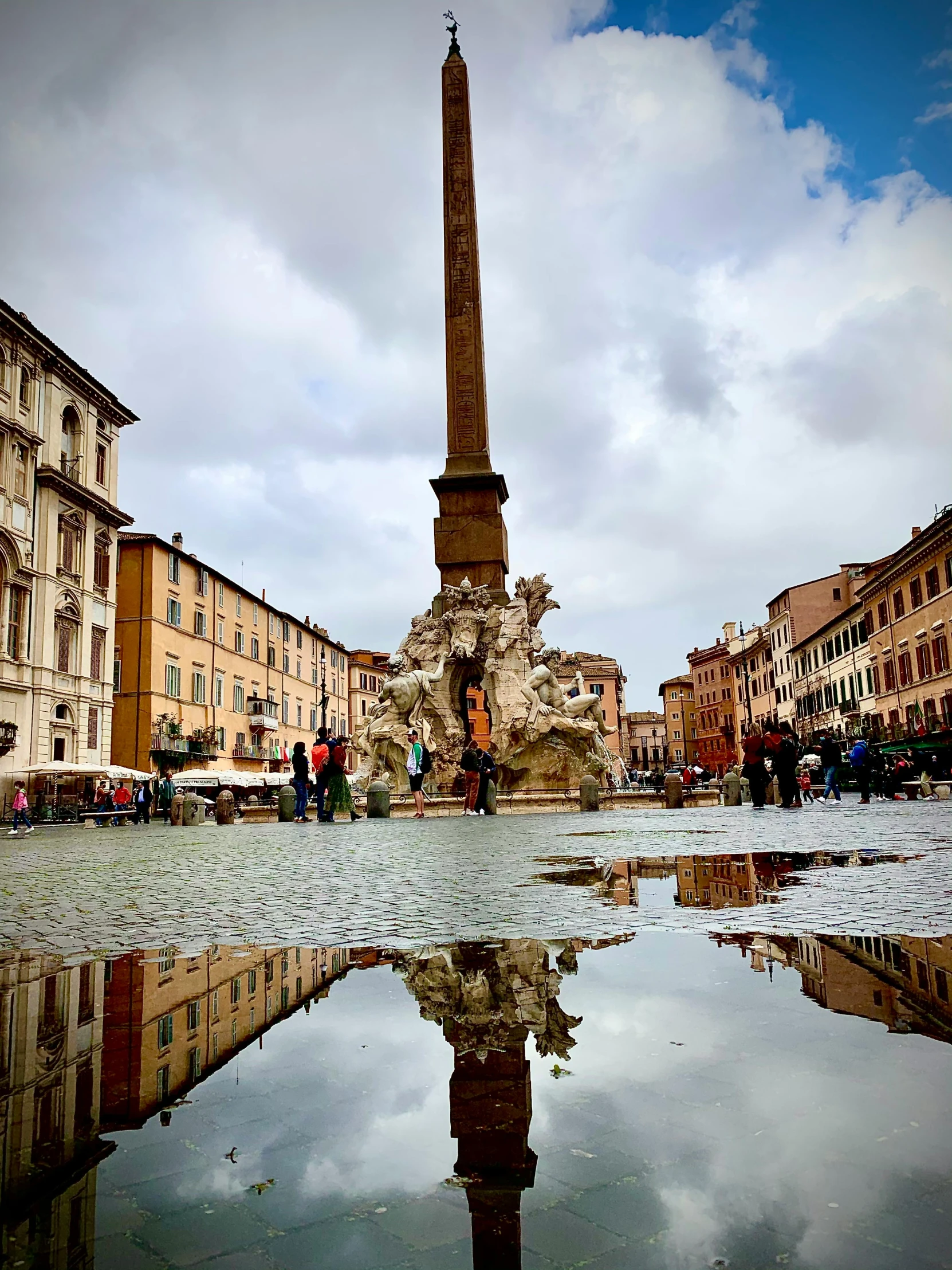 a reflection of a monument in a puddle of water, inspired by Andrea Pozzo, pexels contest winner, in a city with a rich history, square, drinking, slide show