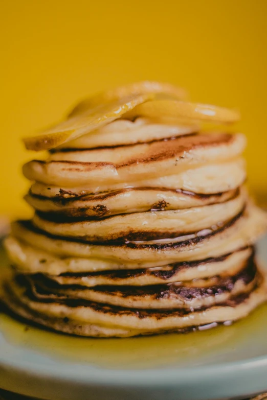 a stack of pancakes sitting on top of a white plate, a portrait, unsplash, yellow and black, made of glazed, burnt, thumbnail