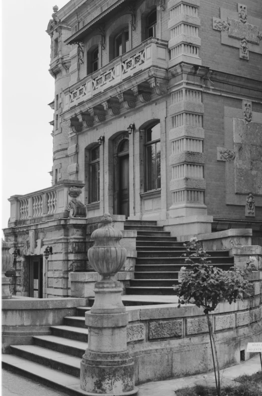 a black and white photo of a large building, a black and white photo, inspired by Sydney Prior Hall, heidelberg school, stone steps, ( ( photograph ) ), ornamentation, 1 9 8 5 photograph