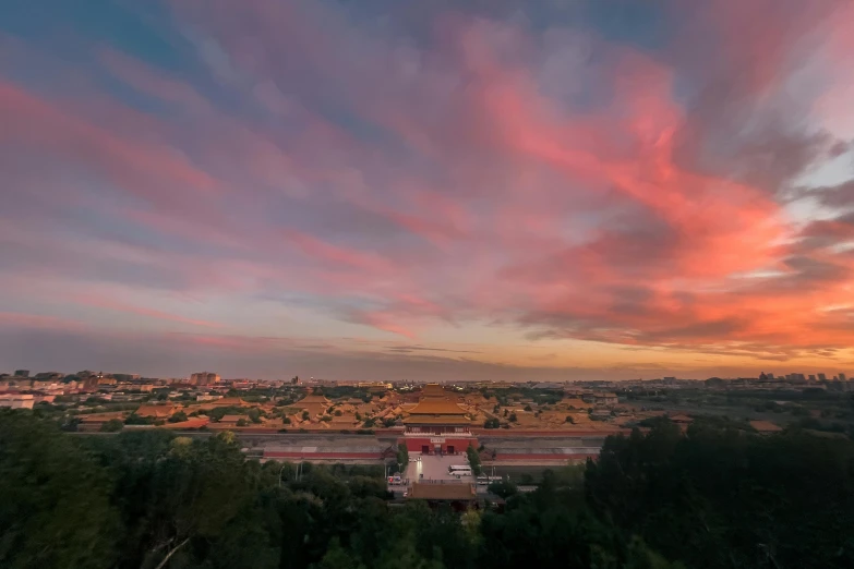 a view of a city from the top of a hill, by Daniel Gelon, pexels contest winner, forbidden city, pink clouds, sunset + hdri, drone photo