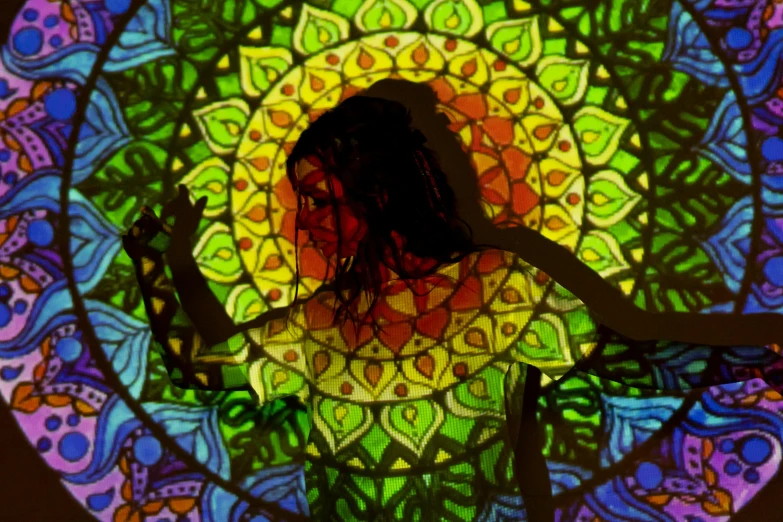 a woman standing in front of a stained glass window, psychedelic art, rasta, with backlight, dance meditation, round-cropped