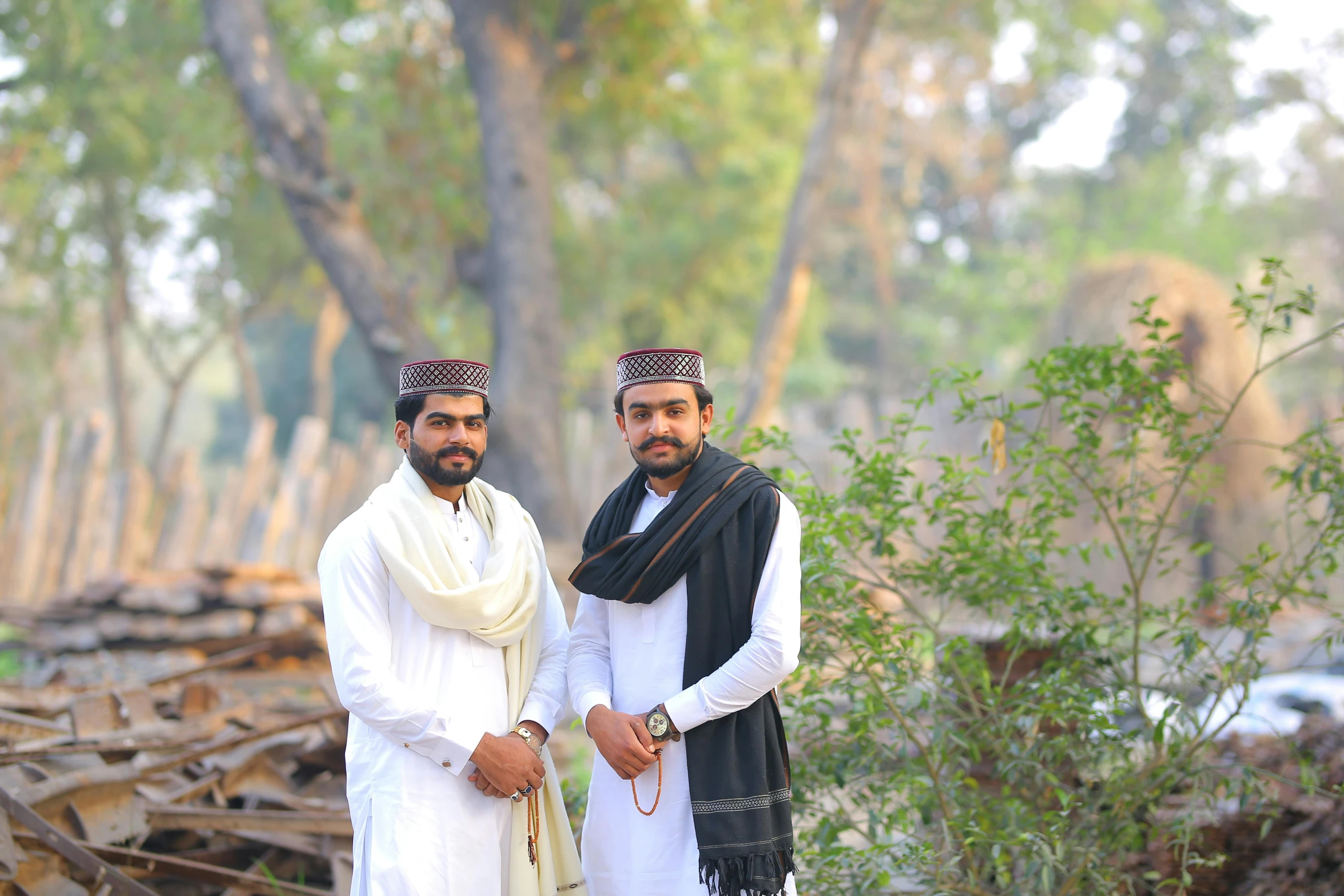 a couple of men standing next to each other, by Riza Abbasi, pexels contest winner, hurufiyya, wearing white cloths, lookalike, brothers, background image