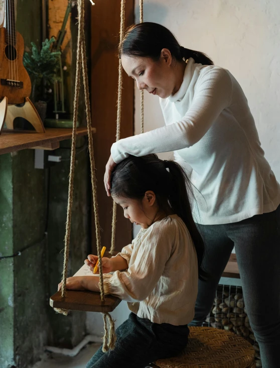 a woman helping a little girl on a swing, inspired by Will Barnet, pexels contest winner, interactive art, on a wooden tray, low quality photo, asian female, inspect in inventory image