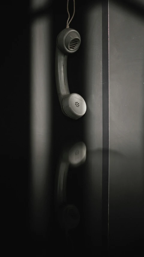 a black and white photo of a telephone, inspired by Robert Mapplethorpe, conceptual art, door to lab, demur, 8k detail, cast glass