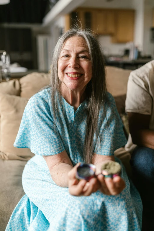 a man and a woman sitting on a couch, a portrait, pexels contest winner, marijuana buds, paua shell, older woman, she is smiling and excited