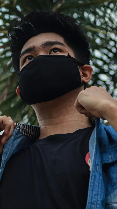 a close up of a person wearing a face mask, by Adam Rex, pexels contest winner, wearing a black shirt, jakarta, wearing tanktop, switch