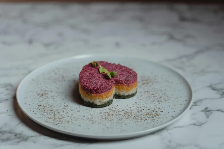 a close up of a plate of food on a table, by Emma Andijewska, red velvet, multi - coloured, ground meat, fubuki