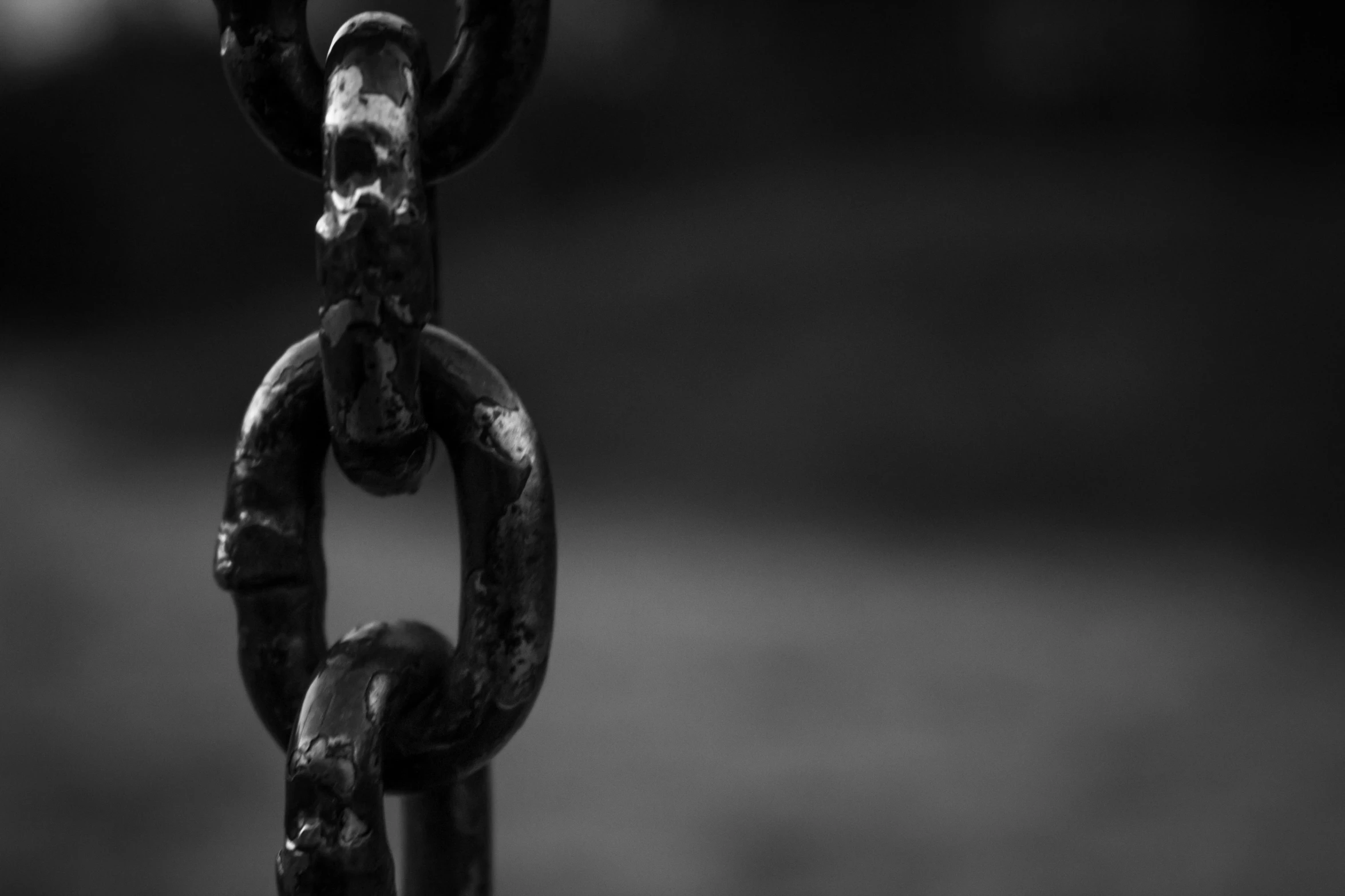 a black and white photo of a chain, unsplash, rust, black jewellery, strength, painted black