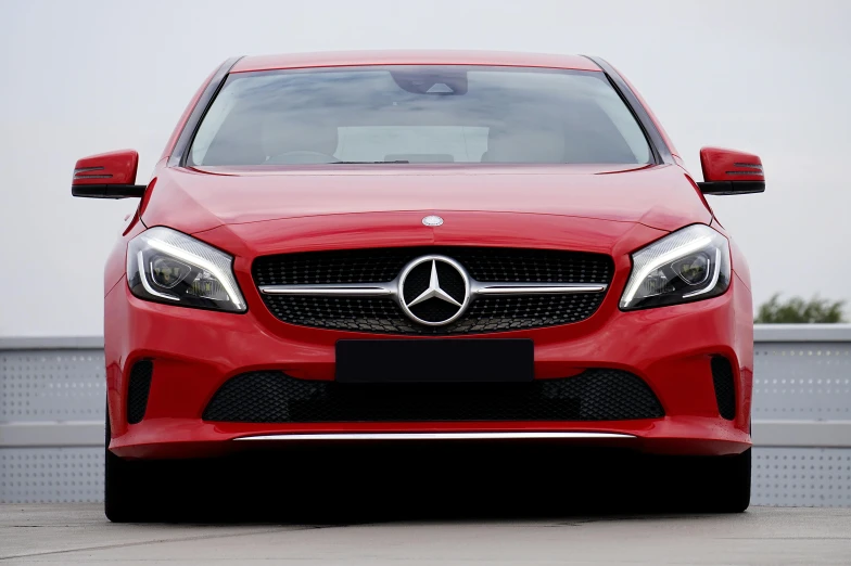 a red mercedes car parked in a parking lot, pexels contest winner, square, frontal realistic, glossy plastic, front