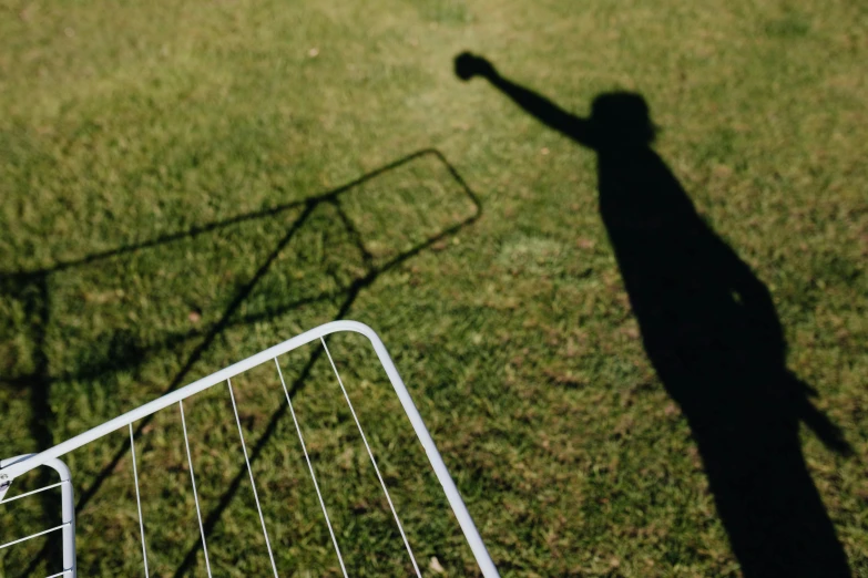 a shadow of a person throwing a frisbee, an album cover, pexels contest winner, lawn, newton's cradle, beds of shadows, instagram photo