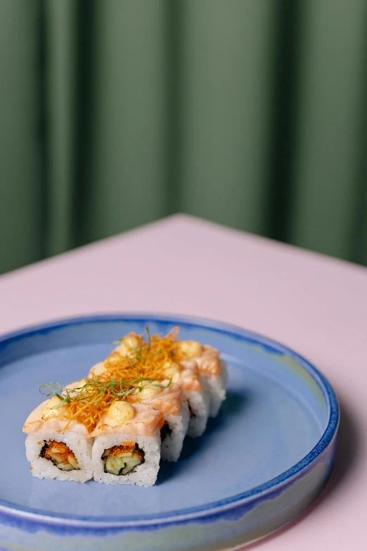 a close up of a plate of food on a table, inspired by Maki Haku, with a blue background, melbourne, stuffed, thumbnail