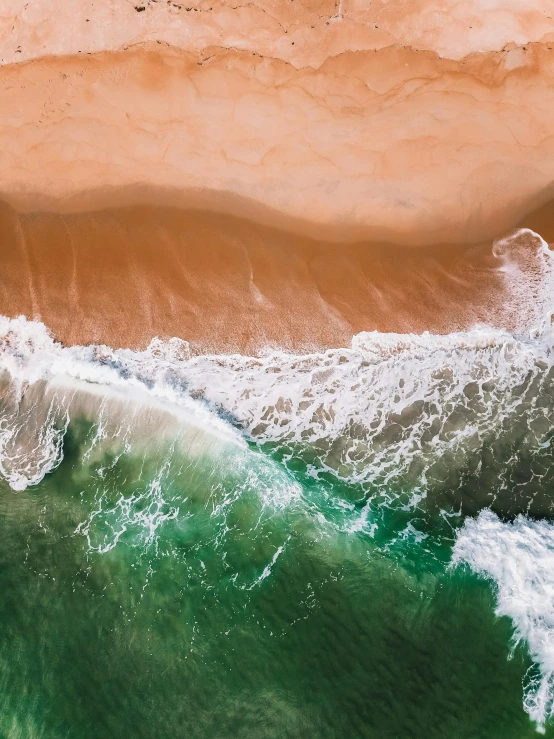 a large body of water next to a sandy beach, pexels contest winner, ocean spray, bird\'s eye view, profile picture, vivid and detailed