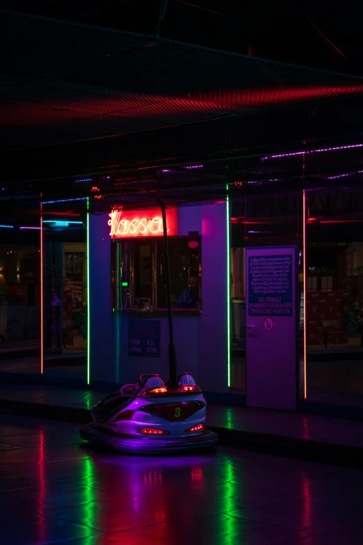 a bumper car in a dark room with neon lights, by Adam Marczyński, neon lights above shops, high quality photo, dancefloor kismet, taken in the early 2020s