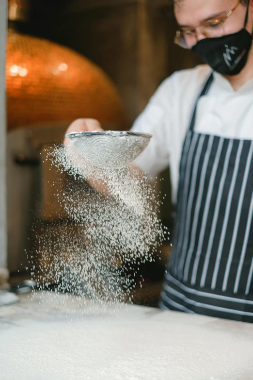 a man in an apron pouring flour into a bowl, a stipple, inspired by Richmond Barthé, trending on unsplash, kinetic pointillism, close up of single sugar crystal, gourmet restaurant, full of sand and glitter, grain”