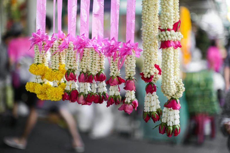 a bunch of flowers hanging from a string, temple fair, square, in a row, subtle detailing
