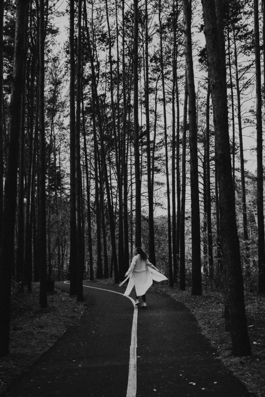 a person riding a skateboard in the middle of a forest, a black and white photo, by Lucia Peka, unsplash contest winner, conceptual art, dressed in white robes, ((trees)), girl walking in dark forest, oyasumi punpun