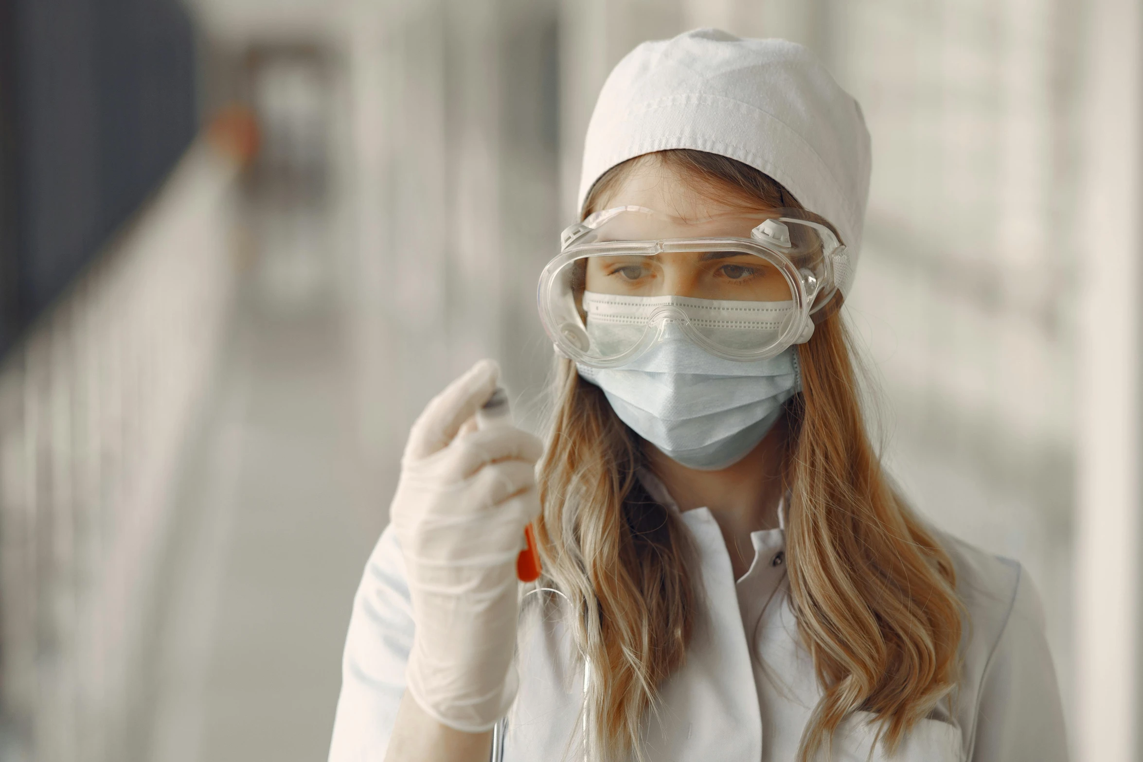 a woman in a lab coat and goggles holding a test tube, by Emma Andijewska, worksafe. instagram photo, cinematic quality, thumbnail, erin moriarty