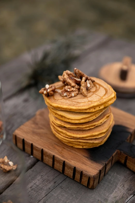 a stack of pancakes sitting on top of a wooden table, a portrait, trending on pexels, pumpkin, walnut wood, detailed product image, 6 pack