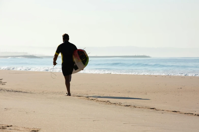 a man walking on a beach with a surfboard, pexels contest winner, walking to the right, south african coast, rocha, profile image