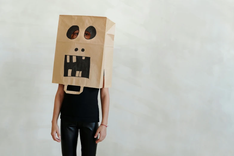 a person with a paper bag on their head, inspired by Sarah Lucas, trending on pexels, pirate robot, square face, costume desig, cut out