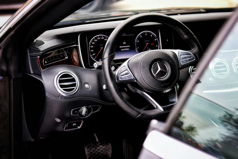 a close up of a steering wheel in a car, mercedez benz, thumbnail, displayed, detailing